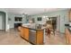 Large eat-in kitchen featuring a breakfast bar and an open floor plan leading into the living room at 16386 W Sierra St, Surprise, AZ 85388