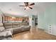 Open concept living room with tile flooring, and adjacent eat-in kitchen with wooden cabinetry at 16386 W Sierra St, Surprise, AZ 85388