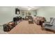 Inviting living area with ample seating, large windows, and carpeted floors at 16386 W Sierra St, Surprise, AZ 85388