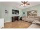 Comfortable living room with tile flooring, ceiling fan, and a relaxing reclining sofa at 16386 W Sierra St, Surprise, AZ 85388