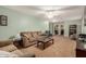 Bright living room with carpeted flooring, comfortable seating, and an open doorway at 16386 W Sierra St, Surprise, AZ 85388