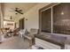 Covered patio area with seating and a ceiling fan, great for outdoor relaxation at 16386 W Sierra St, Surprise, AZ 85388