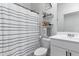 Clean bathroom featuring a shower-tub combo, decor shelves, and single sink vanity at 16617 W Desert Mirage Dr, Surprise, AZ 85388