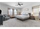 Bedroom featuring cozy seating, nightstands, and lots of light at 16617 W Desert Mirage Dr, Surprise, AZ 85388