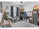 bedroom with comfortable seating area, shelving, and plenty of space for play at 16617 W Desert Mirage Dr, Surprise, AZ 85388