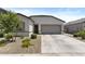Lovely home featuring a two-car garage, neutral color palette, and low-maintenance landscaping at 16617 W Desert Mirage Dr, Surprise, AZ 85388