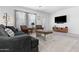 Well-lit living room with cozy seating and entertainment center at 16617 W Desert Mirage Dr, Surprise, AZ 85388