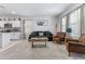 Bright living room featuring a comfortable sofa, armchairs, and stylish decor at 16617 W Desert Mirage Dr, Surprise, AZ 85388