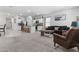 Open-concept living area flows to the kitchen, modern furniture, and neutral tones at 16617 W Desert Mirage Dr, Surprise, AZ 85388