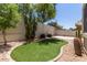 Landscaped backyard with decorative stone, artificial turf and mature desert landscaping at 16813 S 30Th Ave, Phoenix, AZ 85045