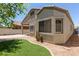 Exterior shot showing the neatly landscaped backyard with a patch of green grass at 16813 S 30Th Ave, Phoenix, AZ 85045