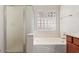 Bathroom with shower and tub combo, and decorative glass block window at 16813 S 30Th Ave, Phoenix, AZ 85045