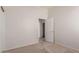 Neutral-toned bedroom with carpet flooring and a door leading to an ensuite at 16813 S 30Th Ave, Phoenix, AZ 85045