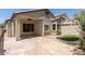 Exterior view of the house and its covered flagstone patio and well-maintained lawn at 16813 S 30Th Ave, Phoenix, AZ 85045