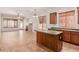 Open-concept living area showcasing kitchen island, tile floors, and natural light at 16813 S 30Th Ave, Phoenix, AZ 85045