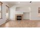Open-concept living room featuring a fireplace, tile flooring, and a sliding glass door at 16813 S 30Th Ave, Phoenix, AZ 85045