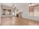 Spacious living room featuring tile flooring, a ceiling fan, and a cozy fireplace at 16813 S 30Th Ave, Phoenix, AZ 85045