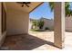 View of the flagstone-paved outdoor covered patio with ceiling fan overlooking the private backyard at 16813 S 30Th Ave, Phoenix, AZ 85045