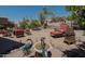 Lush backyard with desert landscaping, a fountain, lounge chairs, and an outdoor seating area at 17214 E Alta Loma --, Fountain Hills, AZ 85268