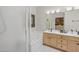 Bright bathroom featuring double sinks, wooden cabinets, a soaking tub, and a separate shower at 17214 E Alta Loma --, Fountain Hills, AZ 85268