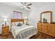 Cozy bedroom with wood flooring, natural light, and a wooden dresser, offering a peaceful retreat at 17214 E Alta Loma --, Fountain Hills, AZ 85268