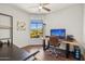 Office with a wood desk, accent wall art, ceiling fan, and a view of the community at 17214 E Alta Loma --, Fountain Hills, AZ 85268