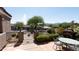 Inviting outdoor patio with a view of a fountain and distant mountains, with seating around an outdoor fireplace at 17214 E Alta Loma --, Fountain Hills, AZ 85268