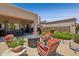 Spacious outdoor patio featuring multiple seating areas, lush landscaping, and travertine pavers at 17214 E Alta Loma --, Fountain Hills, AZ 85268