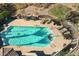 Aerial view of a community pool with lounge chairs, tables, and a pristine swimming area at 17214 E Alta Loma --, Fountain Hills, AZ 85268