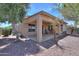 View of the covered back patio with a small palm tree and low maintenance landscaping at 1880 E Birch St, Casa Grande, AZ 85122