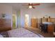Open bedroom showcasing a ceiling fan, offering a view to the en-suite bath, blending comfort and style at 1880 E Birch St, Casa Grande, AZ 85122