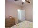 Comfortable bedroom featuring a ceiling fan, view to hallway and dresser for a modern feel at 1880 E Birch St, Casa Grande, AZ 85122