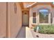 Inviting front entry with a screen door, neutral stucco, desert landscaping and a small window at 1880 E Birch St, Casa Grande, AZ 85122