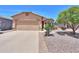 Single-story home featuring a two-car garage, neutral stucco, desert landscaping and a tile roof at 1880 E Birch St, Casa Grande, AZ 85122