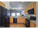 Bright kitchen features maple cabinets, granite counters, and black appliances at 1880 E Birch St, Casa Grande, AZ 85122