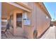 Exterior view of a covered patio with outdoor water heater and view of a well maintained walkway at 1880 E Birch St, Casa Grande, AZ 85122