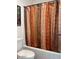 Cozy bathroom with a toilet and bathtub featuring a decorative shower curtain at 1898 N Hubbard Ln, Casa Grande, AZ 85122