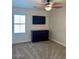 This bedroom features neutral walls, a TV, a ceiling fan and a dresser at 1898 N Hubbard Ln, Casa Grande, AZ 85122