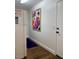 Hallway featuring a refrigerator, dark wood floors and a contemporary art piece at 1898 N Hubbard Ln, Casa Grande, AZ 85122