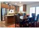 Open concept kitchen with modern appliances, a central island, and adjacent dining area with chairs at 1898 N Hubbard Ln, Casa Grande, AZ 85122