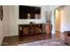 Cozy living space showcasing a wooden media console, decorative vase, and a partial view of a brown sofa at 1898 N Hubbard Ln, Casa Grande, AZ 85122