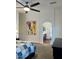 Spacious main bedroom features a ceiling fan, artwork, and ensuite bathroom, creating a serene retreat at 1898 N Hubbard Ln, Casa Grande, AZ 85122
