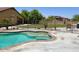 Backyard pool featuring mature trees and wrought iron safety fence at 1898 N Hubbard Ln, Casa Grande, AZ 85122