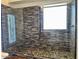 Walk-in shower boasts custom tilework, river rock floor, and a glass enclosure for a spa-like experience at 1898 N Hubbard Ln, Casa Grande, AZ 85122