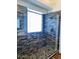 Walk-in shower features custom tilework, river rock floor, and a glass enclosure at 1898 N Hubbard Ln, Casa Grande, AZ 85122