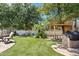 Lush backyard featuring artificial grass, a treehouse, a grill, and comfortable seating at 19339 E Mockingbird Dr, Queen Creek, AZ 85142