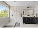 Sleek bathroom with a double vanity, a large window, and a glass-enclosed shower at 19339 E Mockingbird Dr, Queen Creek, AZ 85142