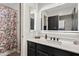 Modern bathroom with a backlit mirror, stylish vanity, and a shower with patterned curtain at 19339 E Mockingbird Dr, Queen Creek, AZ 85142