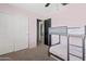 Bedroom featuring a bunk bed, closet, and neutral carpet, creating a cozy atmosphere at 19339 E Mockingbird Dr, Queen Creek, AZ 85142