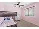 Bright bedroom with a bunk bed, ceiling fan, and window providing natural light at 19339 E Mockingbird Dr, Queen Creek, AZ 85142